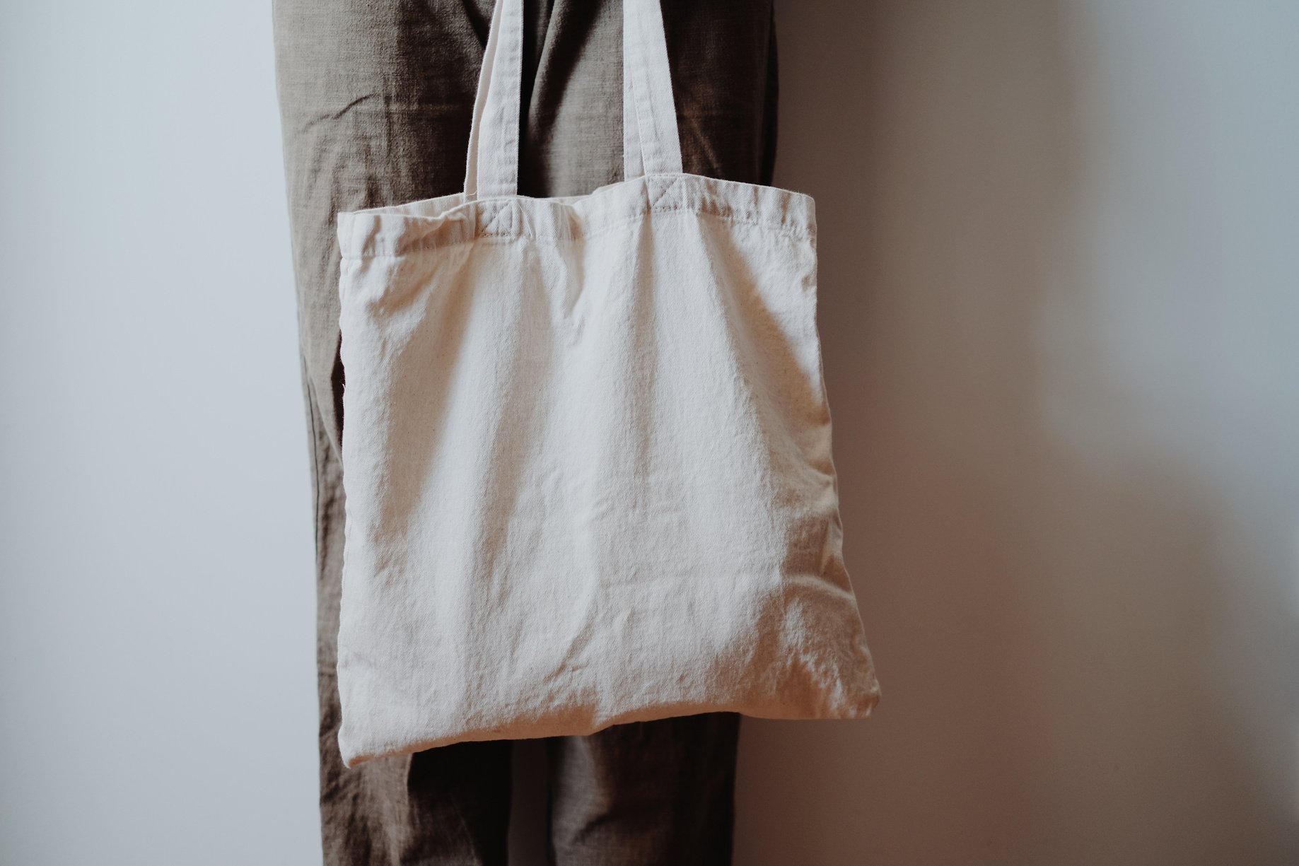 Woman using white canvas tote bag