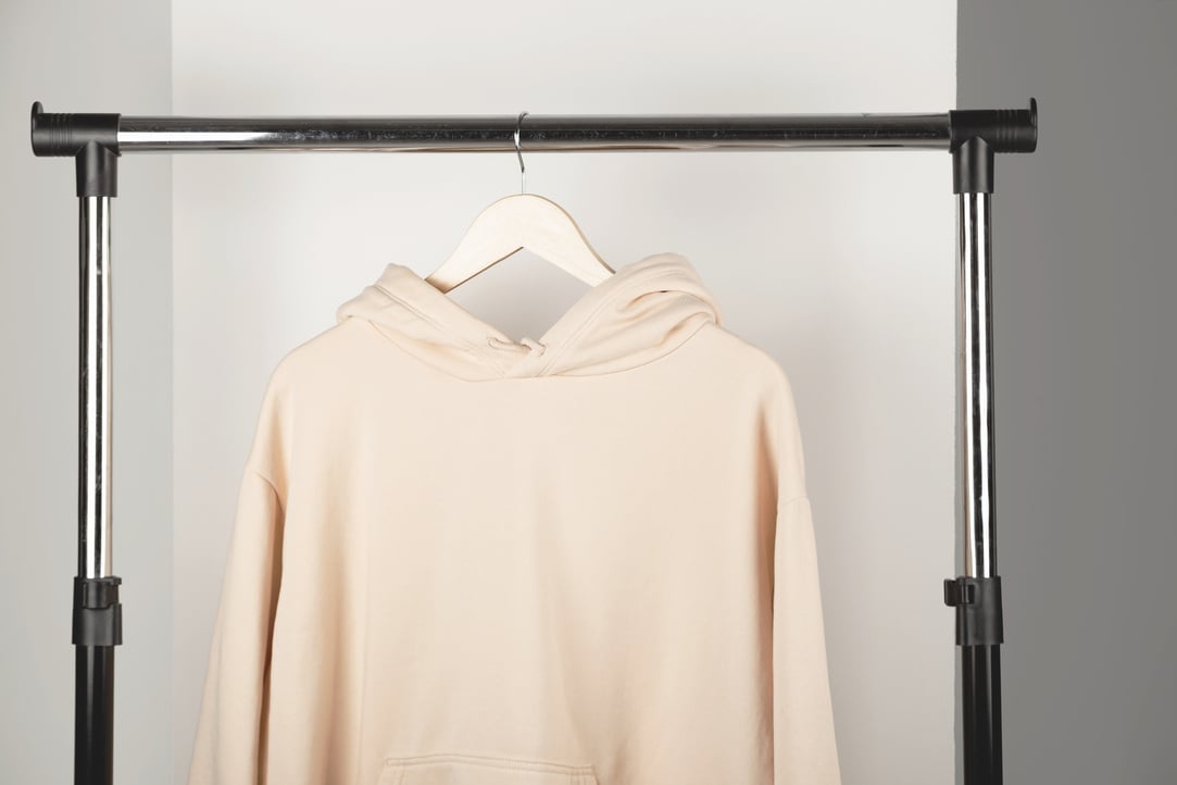 Beige Sweatshirt Hanging on a Rack